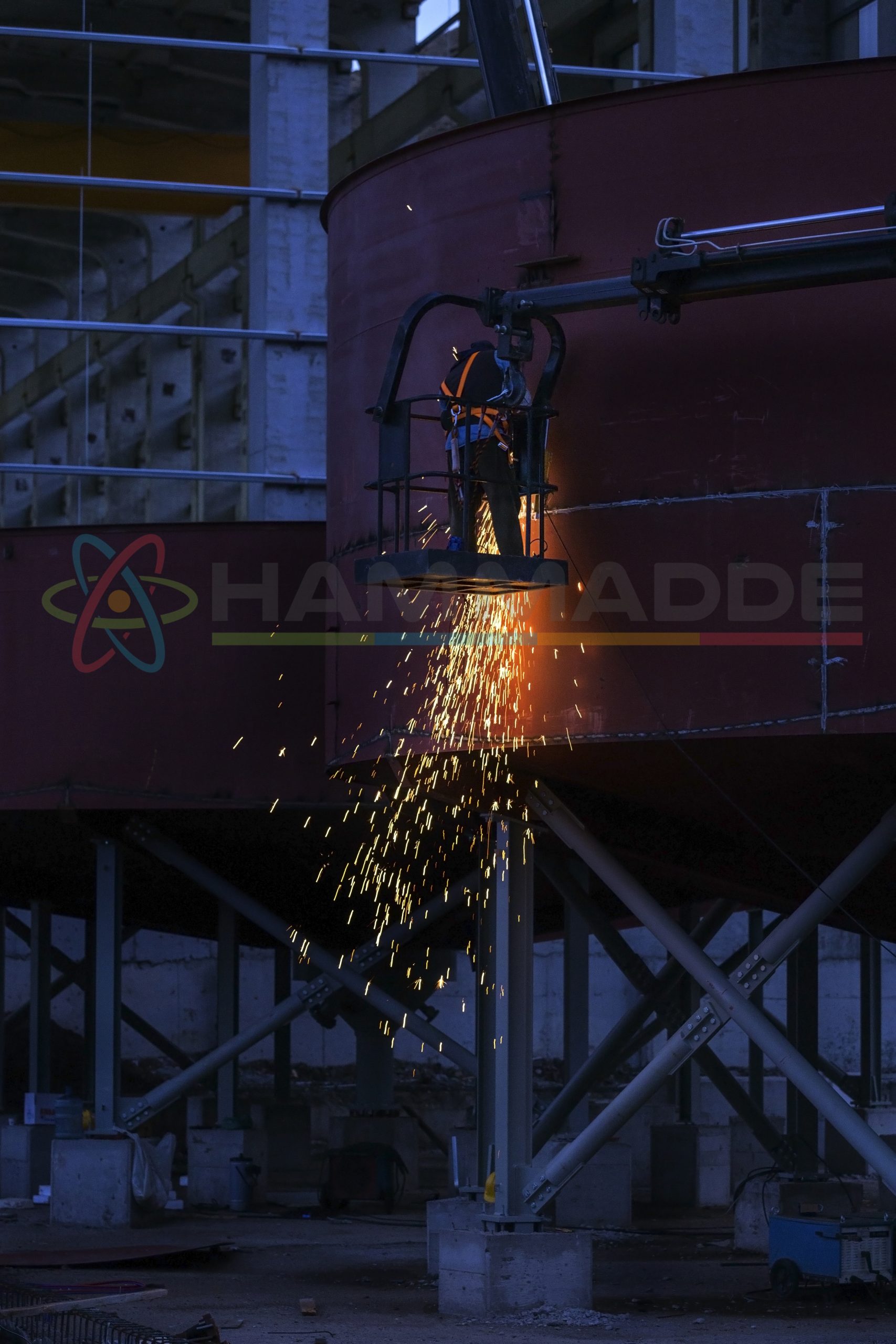 The welder is welding and grinding on the thickener tanks in the construction site (Series -3).